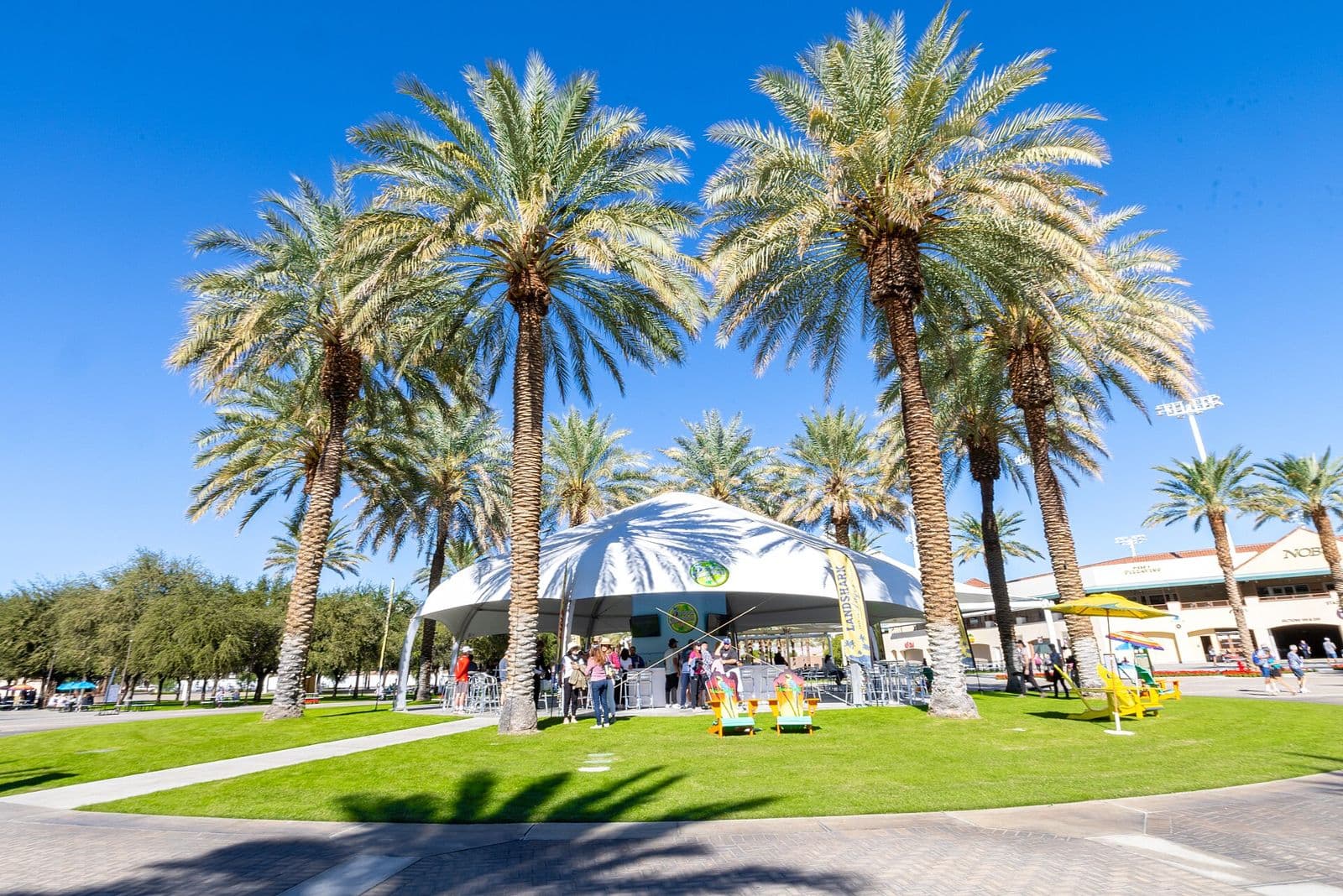 Hospitality tent, branded feather flag and lounge chairs at a pickleball tournament at Indian Wells Tennis Garden